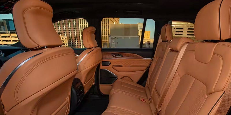 View of the spacious interior of a 2024 Jeep Grand Cherokee with tan leather seats