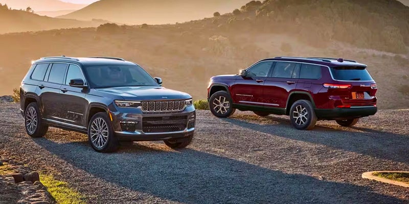 Two 2024 Jeep Grand Cherokees parked opposite of one another on rugged terrain