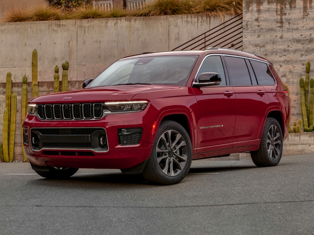 A red 2024 Jeep Grand Cherokee L parked on a city street