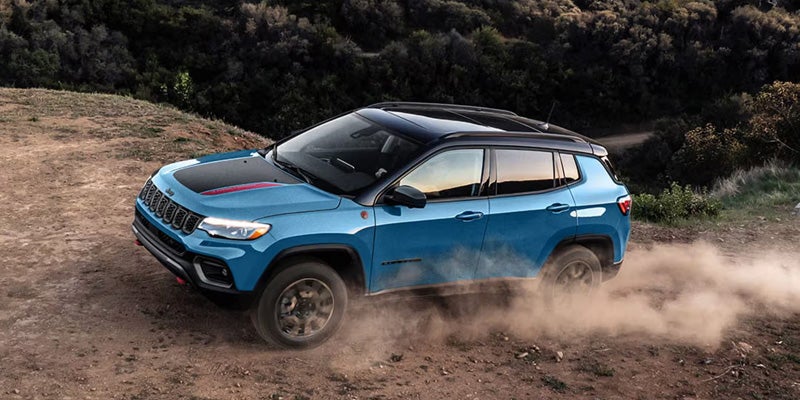 Blue Jeep Compass dirt drive