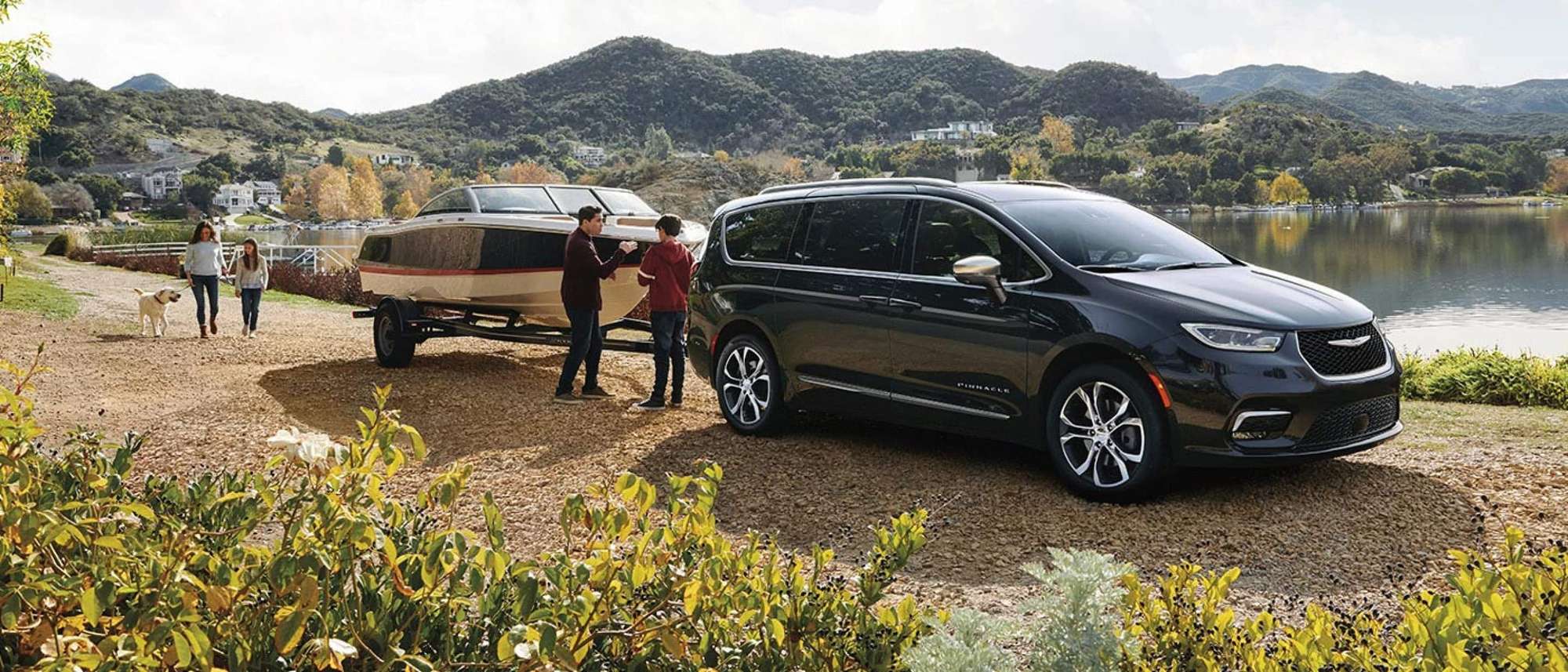 Chrysler Pacifica Pinnacle parked at a lake with a boat and people nearby, a Pacifica for Bowie, TX families